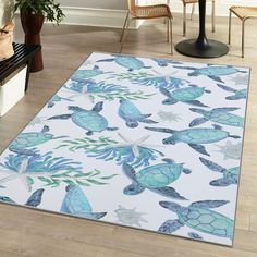 a blue and white area rug with sea turtle designs on the floor next to a chair