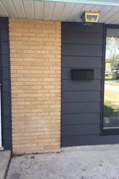 a brick building with a black door and window