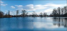 a large body of water with trees in the background and blue skies above it on a sunny day