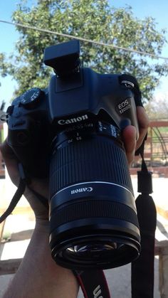 a person holding up a camera in their hand