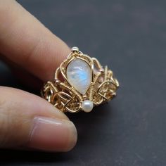 Very elaborate and ornate Victorian court ring. Made of moonstone, pearl and 14k gold filled wire.  It's a wonderful handmade craft.  Express your love and give her the best ring. It also can be a perfect gift for yourself or your friends. -------------------------- D E T A I L S * The natural stone comes from Indian * Other materials are 100% Top quality 14k gold filled from USA * Perfect for someone with sensitive skin ❤  * Each piece of jewelry is handmade with love and care ❤  * Comes in a branded gift box   -------------------------- 1 4 K  G O L D  F I L L E D  * Gold filled jewelry can last a lifetime if it is cared for properly * It is made with a thick layer of 14k gold on top of another metal, but this layer contains almost 100% more real gold than gold plated jewellery which mak Wire Crochet Jewelry, Engagement Gifts For Her, Wire Jewelry Making, Wire Jewelry Designs, Wire Wrapped Ring, Vintage Inspiration, Wire Work Jewelry, Work Jewelry, Handmade Wire Jewelry