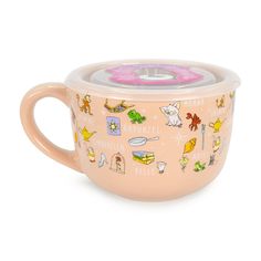 a pink cup with pictures on it and a lid in the shape of a mug