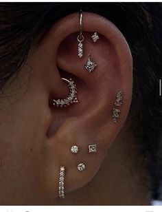 an ear with three different piercings on it and the caption reads, i love you