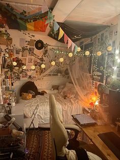 a messy bedroom with lots of decorations on the walls