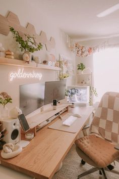 a desk with a computer monitor, keyboard and speakers on it in a home office