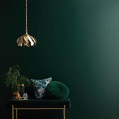 a room with green walls and gold accents