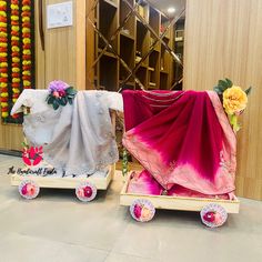 two small carts are decorated with flowers and cloths