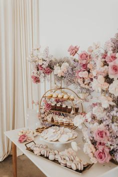 a table topped with lots of desserts and flowers