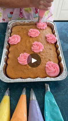 a person is decorating a cake with icing and rosettes on it in the shape of a bear