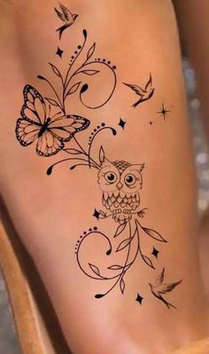 an owl and butterfly tattoo on the side of a woman's leg with butterflies flying around