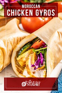 a chicken gyro wrap with lettuce, tomatoes and other vegetables in the background