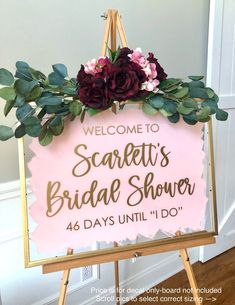 a sign with flowers and greenery on it that says, welcome to sandy's bridal shower 46 days until i do