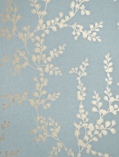 a blue and gold wallpaper with white flowers on it's side, against a light blue background