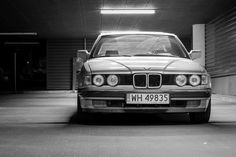 an old bmw is parked in a parking garage