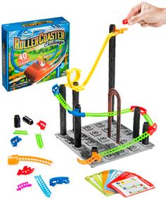 a person is playing with a toy set in the shape of a maze castle and it's contents