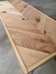 a table made out of wood with wheels on the bottom and one end that has been turned upside down