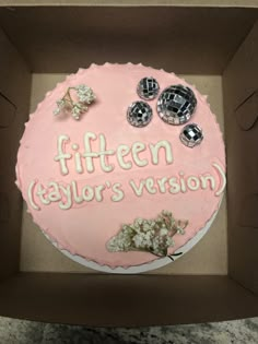 a pink cake in a box that says fifteen taylor's version