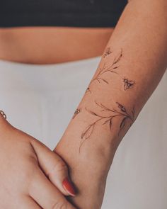 a woman's arm with flowers on it