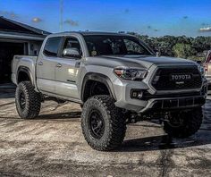 a silver toyota truck parked in front of a house