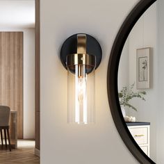 a wall light that is next to a mirror