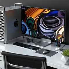 an apple computer sitting on top of a white desk