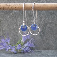 These hoop earrings were handmade from sterling silver and a navy blue enamelled silver disc.  I have hammered the silver hoop to give it added texture and a bit of sparkle. These silver earrings would be a lovely Mothers day gift or Valentines gift.  They are also available in a pale blue colour https://www.etsy.com/uk/listing/627277950/silver-and-enamel-earrings-sterling?ref=shop_home_active_1 although I can make them in the colour of your choice.  Please message me to arrange a different colour if required. You will receive these earrings gift wrapped. Click here to return to Thistledown Wishes home page https://www.etsy.com/uk/shop/ThistledownWishes?ref=seller-platform-mcnav. Click here to see more earrings https://www.etsy.com/uk/shop/ThistledownWishes?ref=seller-platform-mcnav§ion_id Silver Circle Earrings, Long Silver Earrings, Hoop Earrings Silver, Enamel Earrings, Delicate Earrings, Hammered Silver, Etsy Earrings Dangle, Enamel Jewelry, Valentines Gift