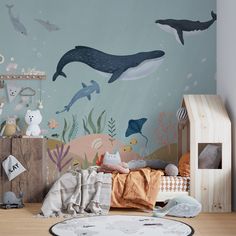 an ocean themed children's room with dolphins and other animals