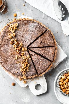 a chocolate pie with nuts on top