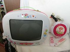 an old television and remotes on a table