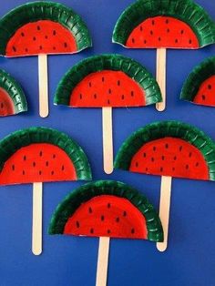 paper plate watermelon popsicles on a blue background