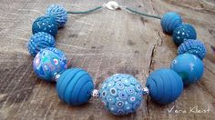 a blue beaded necklace on a wooden surface