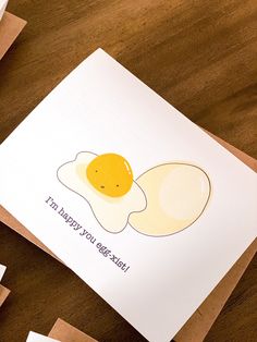 two fried eggs are on top of a card