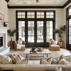 a living room filled with furniture and a fire place in front of a door that leads to a patio