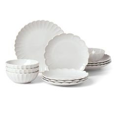 white dishes with scalloped rims and saucers