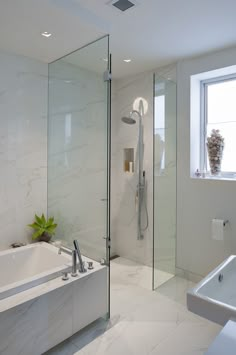 a bathroom with a tub, shower and sink