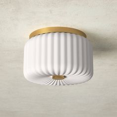 a white and gold ceiling light in a room