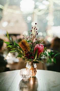 a vase filled with flowers sitting on top of a table