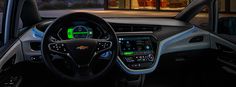 the interior of a chevrolet vehicle with its dashboard and steering wheel illuminated by green lights