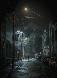 a person walking down a dark street at night