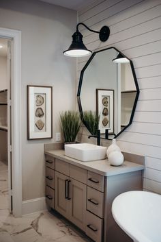 a bathroom with two sinks and a large mirror on the wall above it's counter