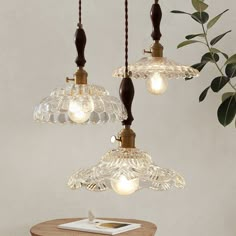 three light fixtures hanging from a ceiling