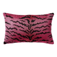 a pink and black animal print pillow on a white background