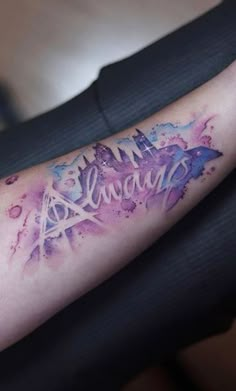 a woman's arm with the words harry potter on it and watercolor splashs