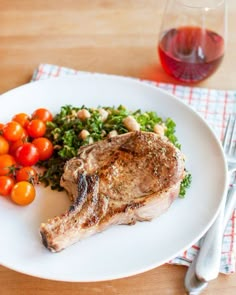 a white plate topped with meat and vegetables