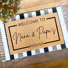 a welcome mat with the words nana & papa's house on it sitting on a wooden table