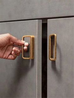 a person is opening the door with their hand