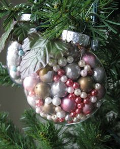 a christmas ornament hanging from a tree filled with baubles and ornaments