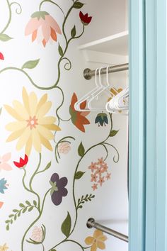 the closet is decorated with floral wallpaper