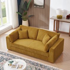 a living room filled with furniture and a large rug on top of a hard wood floor