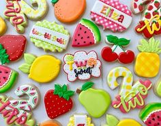 some very pretty decorated cookies in the shape of letters and numbers with fruit on them